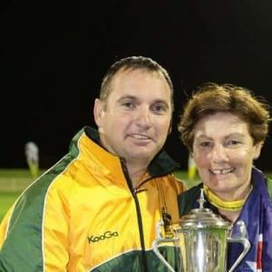 Wayne Grant poses for photo with trophy and another person