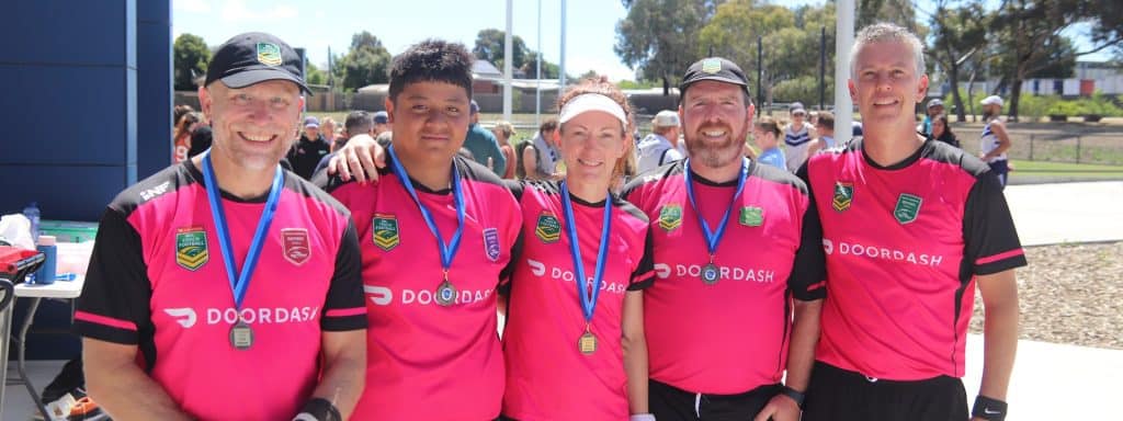 Referees with medals pose for photo