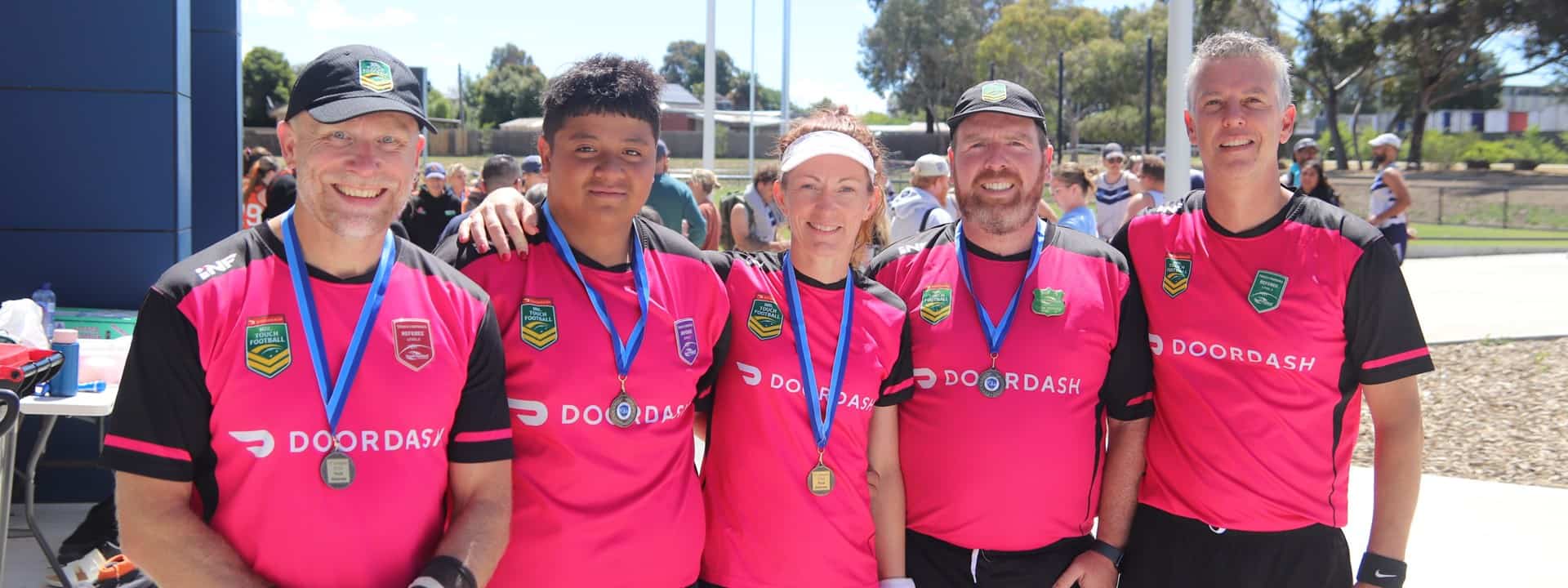 Referees with medals pose for photo
